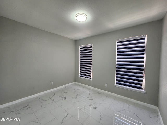 spare room with tile patterned flooring