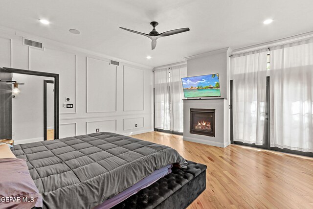 bedroom with ceiling fan and light hardwood / wood-style flooring