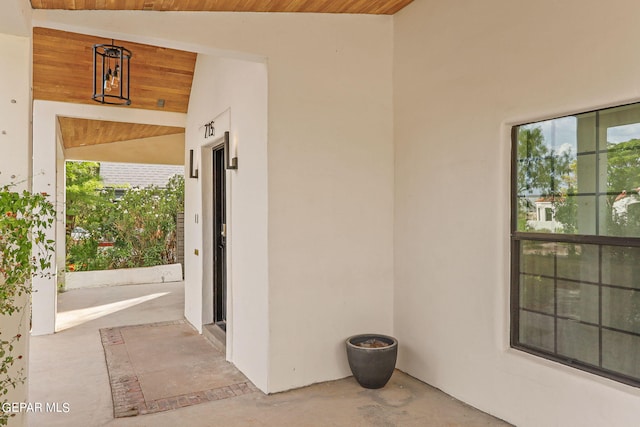 interior space with wood ceiling and lofted ceiling