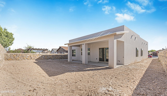 rear view of property featuring a patio