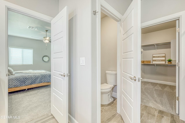 bathroom with toilet and ceiling fan