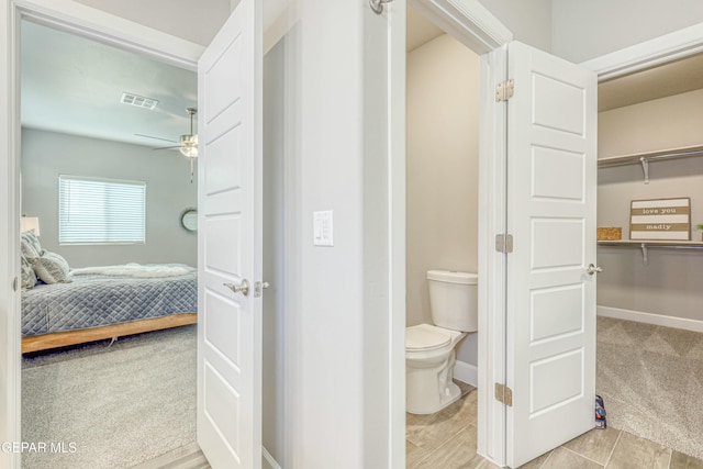 bathroom with tile patterned flooring, ceiling fan, and toilet