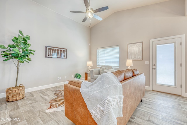 living room featuring ceiling fan, light hardwood / wood-style floors, and high vaulted ceiling