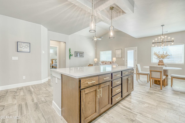 kitchen with ceiling fan with notable chandelier, vaulted ceiling, light hardwood / wood-style flooring, decorative light fixtures, and a kitchen island