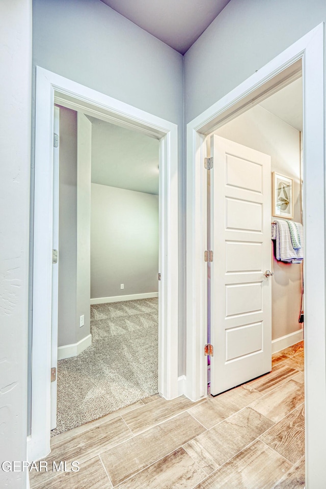 hall with hardwood / wood-style flooring