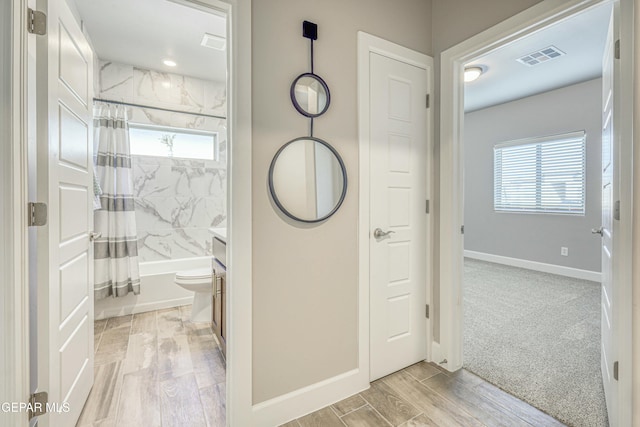 full bathroom with wood-type flooring, vanity, toilet, and shower / bath combo