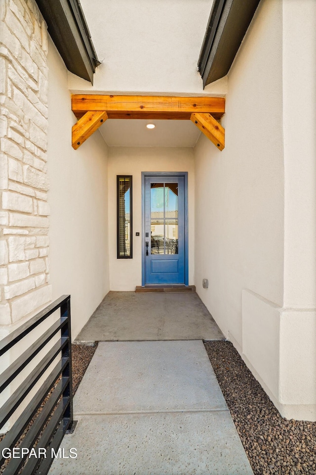 property entrance with stucco siding