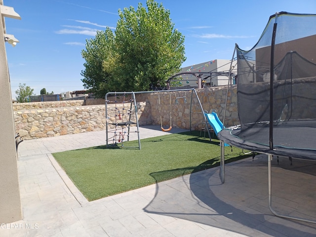 view of yard featuring a patio and a trampoline