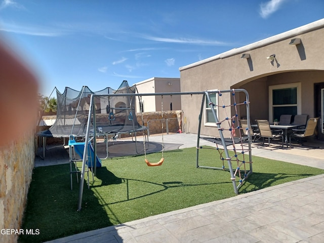 view of yard with a patio and a trampoline