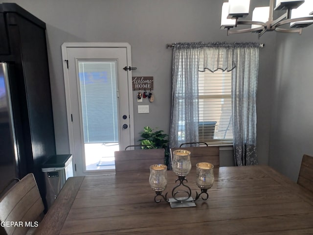 dining area with an inviting chandelier