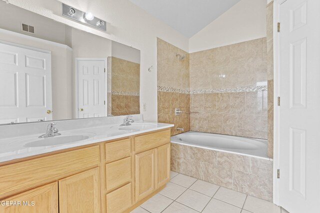 bathroom featuring tile patterned floors, vaulted ceiling, shower with separate bathtub, and vanity