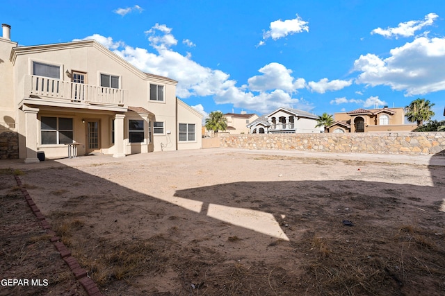 view of yard with a balcony