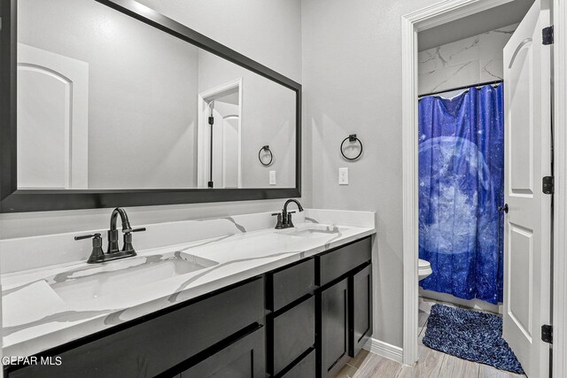 bathroom with vanity, toilet, a shower with curtain, and hardwood / wood-style flooring