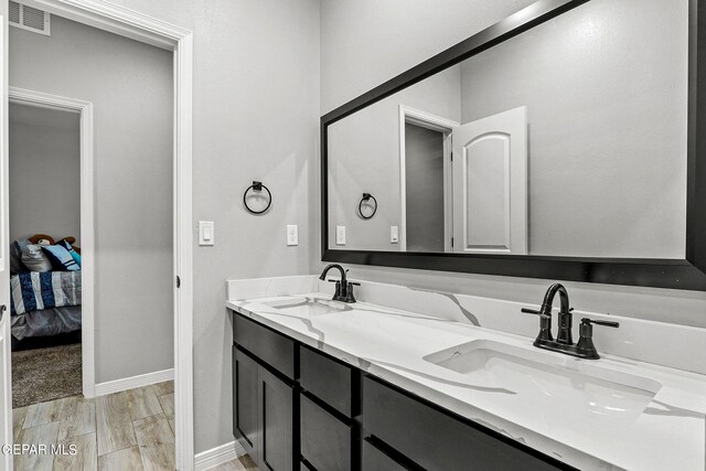 bathroom with hardwood / wood-style flooring and vanity