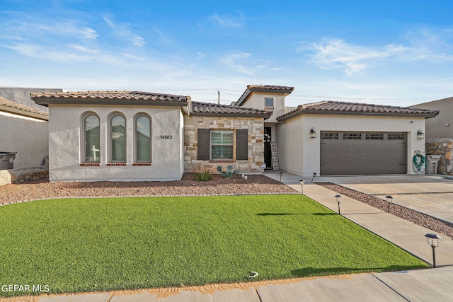 mediterranean / spanish-style home with a front yard and a garage