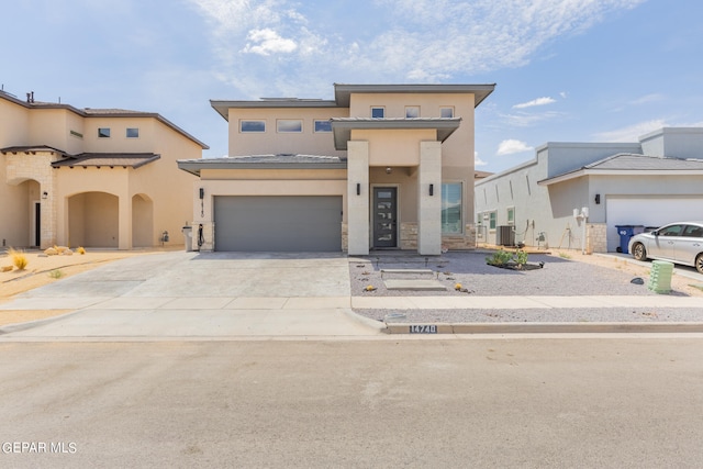 view of front of home with a garage and central AC