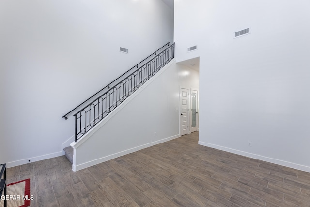 interior space with a high ceiling and hardwood / wood-style floors