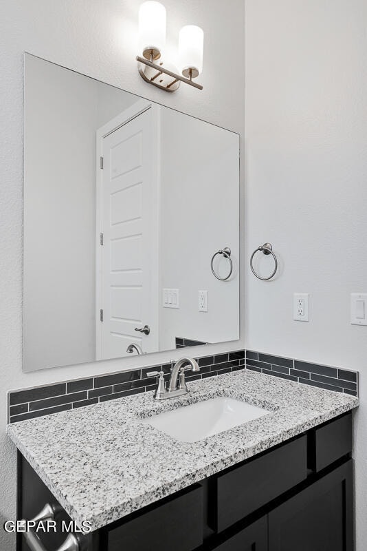 bathroom featuring backsplash and vanity