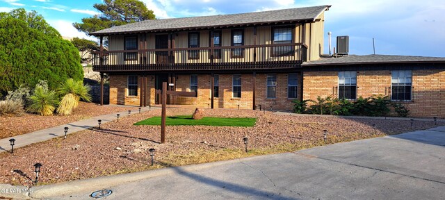 view of front of house with a balcony and central AC unit