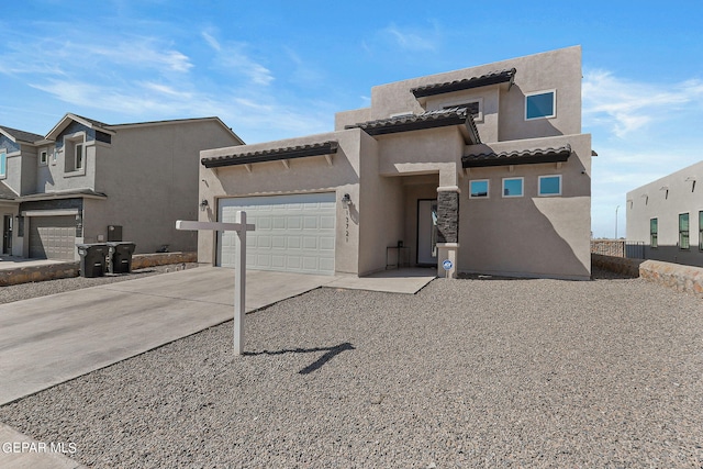 pueblo-style home featuring a garage