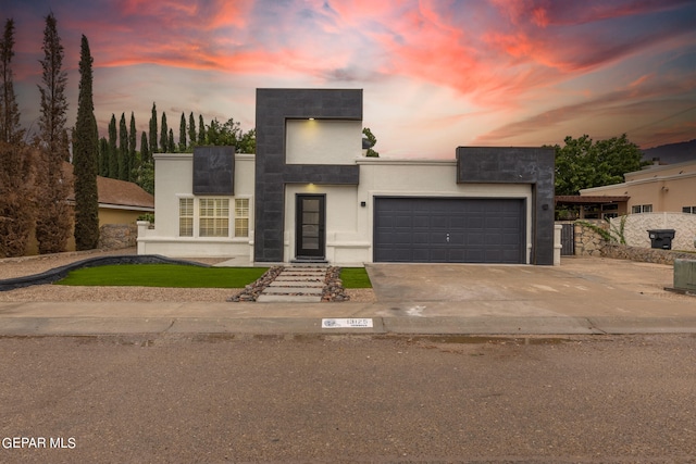 contemporary house with a garage and central air condition unit