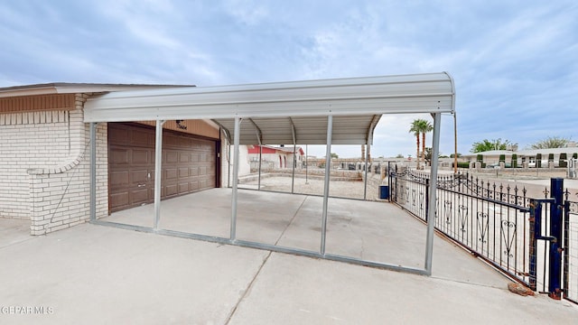 exterior space with a garage, a carport, and fence