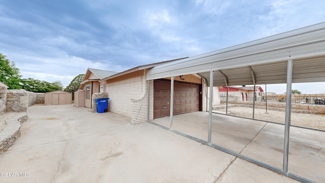 exterior space featuring an outbuilding, fence, a detached garage, and a storage shed