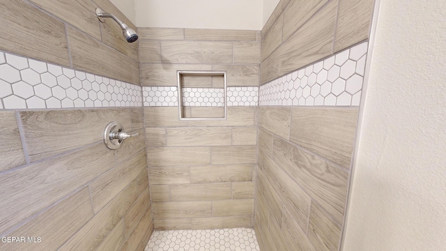 bathroom with a tile shower