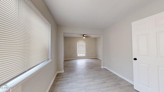 empty room featuring ceiling fan and light hardwood / wood-style floors