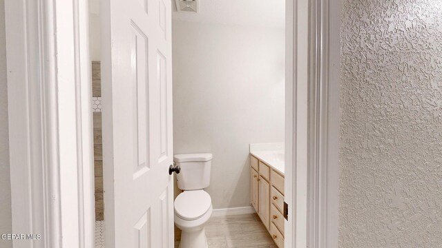 bathroom featuring hardwood / wood-style floors, toilet, and vanity