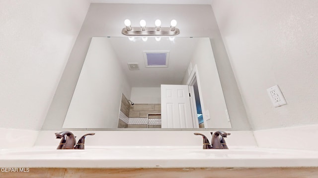 bathroom with vanity and a chandelier