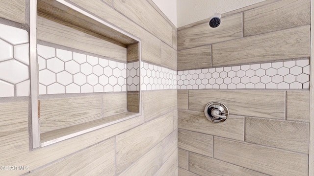 interior details featuring a tile shower