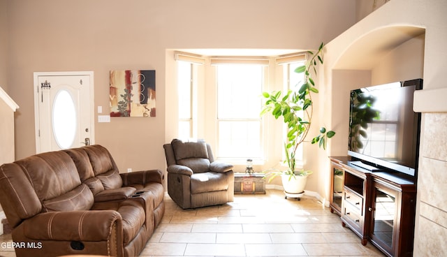 living room with light tile patterned floors and a healthy amount of sunlight