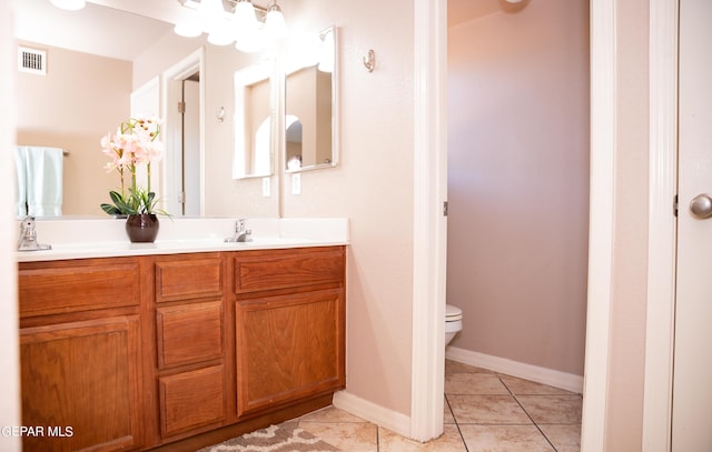 bathroom featuring tile patterned flooring, visible vents, baseboards, toilet, and vanity