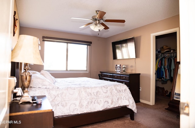 bedroom with baseboards, carpet floors, ceiling fan, a spacious closet, and a closet