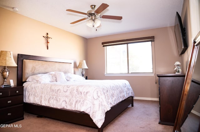 bedroom featuring baseboards, ceiling fan, and carpet flooring