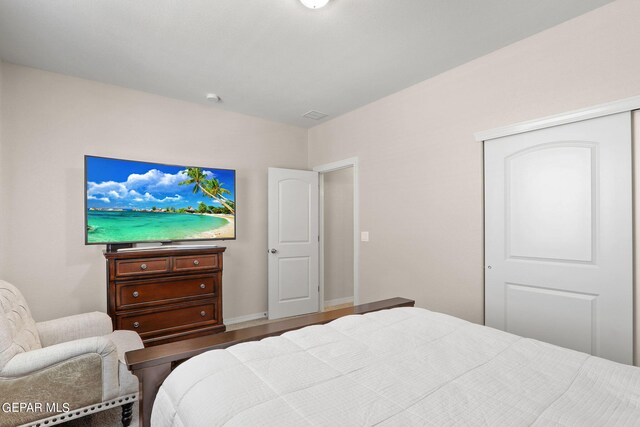 bedroom with hardwood / wood-style flooring