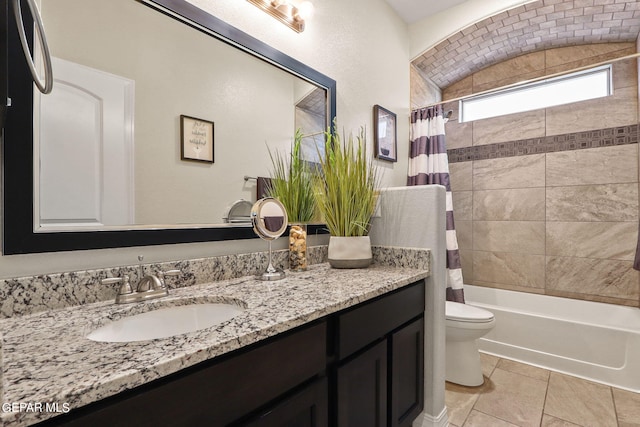 full bathroom with vanity, toilet, tile patterned flooring, and shower / bath combo with shower curtain