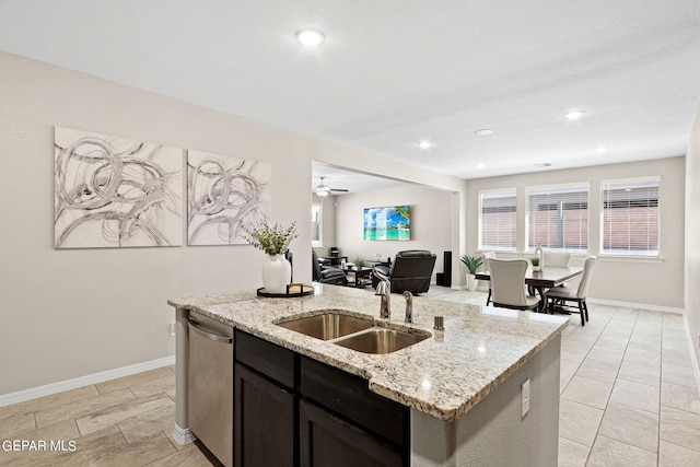 kitchen with dishwasher, light stone counters, sink, ceiling fan, and dark brown cabinetry