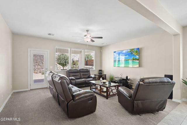 carpeted living room with ceiling fan