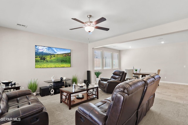 living room with ceiling fan and light carpet