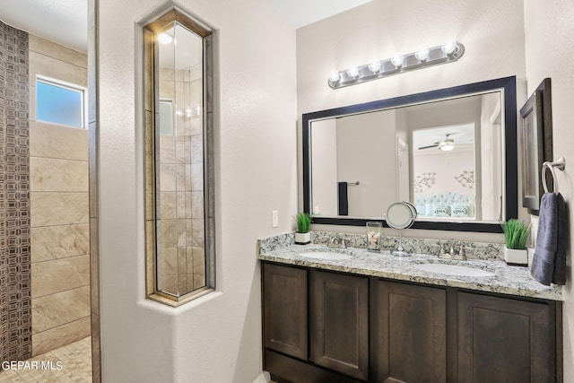 bathroom with ceiling fan, a tile shower, and vanity