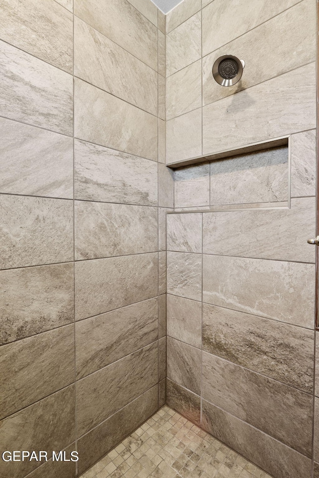 bathroom with a tile shower