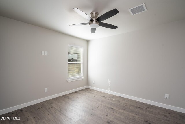 empty room featuring ceiling fan and dark hardwood / wood-style floors