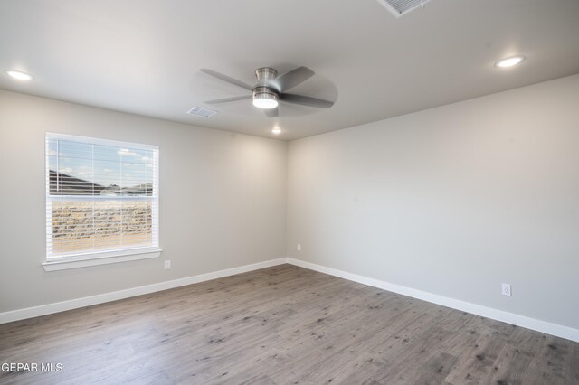 spare room featuring ceiling fan and hardwood / wood-style flooring