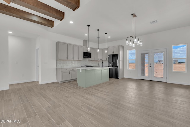 1385 Syrian Desert Dr, Chaparral, NM 88081 - kitchen with black appliances, open floor plan, recessed lighting, light countertops, and decorative backsplash