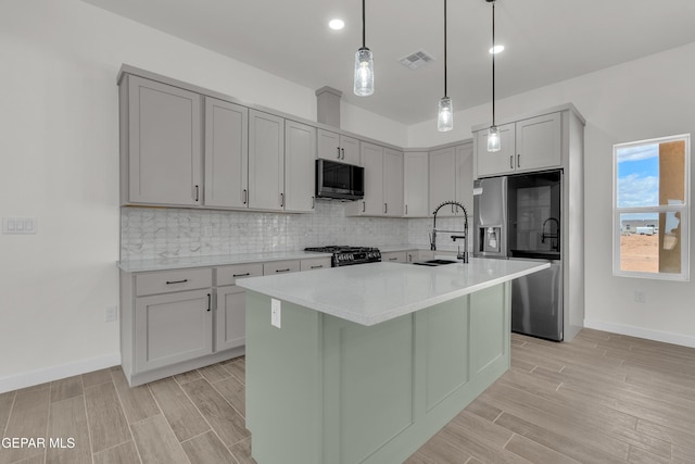 1385 Syrian Desert Dr, Chaparral, NM 88081 - kitchen featuring appliances with stainless steel finishes, light wood-style floors, decorative backsplash, light countertops, and recessed lighting