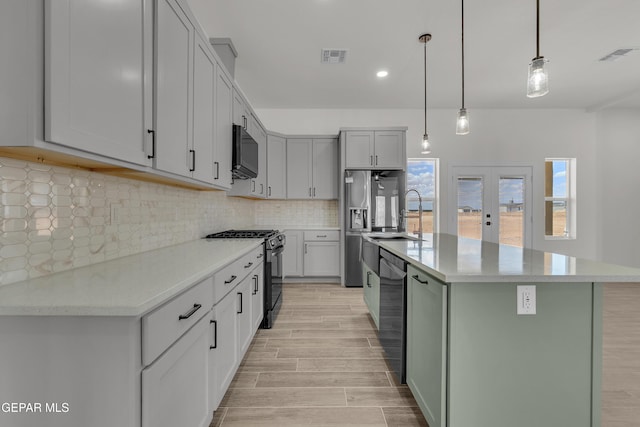 1385 Syrian Desert Dr, Chaparral, NM 88081 - kitchen featuring stainless steel appliances, plenty of natural light, light wood-style floors, a center island with sink, and recessed lighting