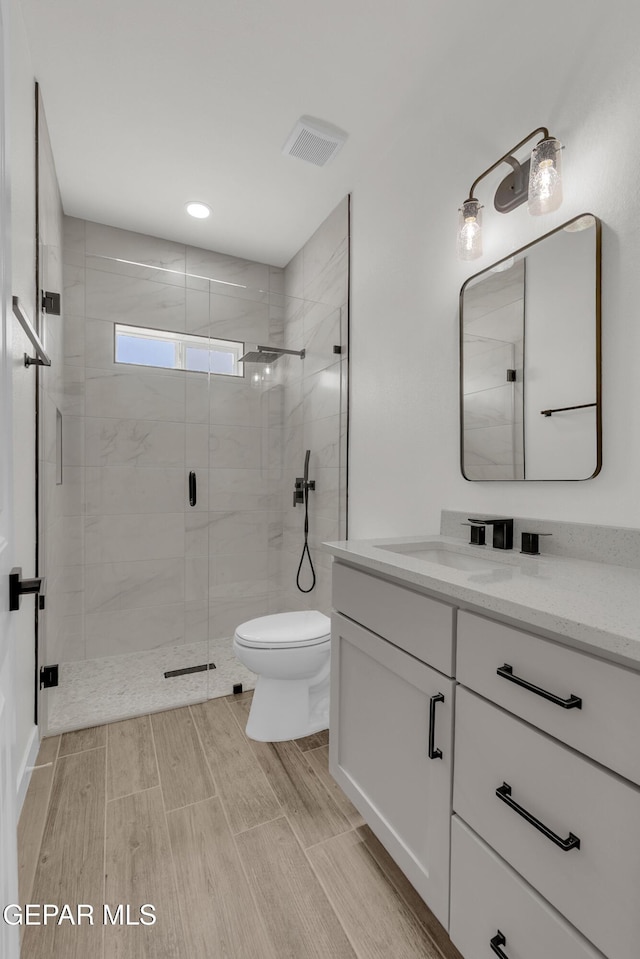 1385 Syrian Desert Dr, Chaparral, NM 88081 - full bathroom featuring vanity, a stall shower, and wood finish floors