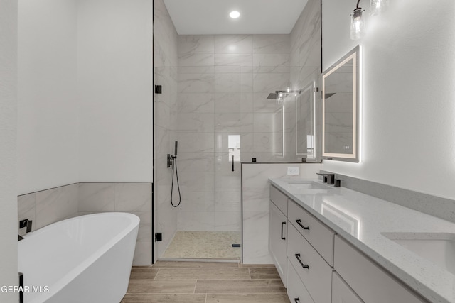 1385 Syrian Desert Dr, Chaparral, NM 88081 - full bathroom with a shower stall, a freestanding tub, double vanity, recessed lighting, and wood finished floors